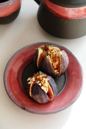 Baked figs stuffed with ricotta cheese, chopped almonds and honey. Fruit dessert