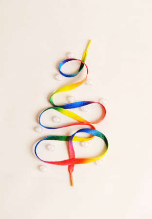 Rainbow lace in shape of Christmas tree, white background, new yearの写真素材