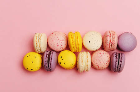 French dessert colorful macarons, pink background