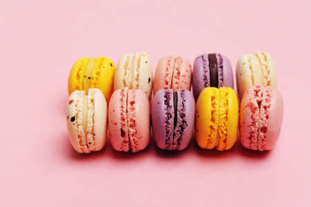 French dessert colorful macarons, pink background
