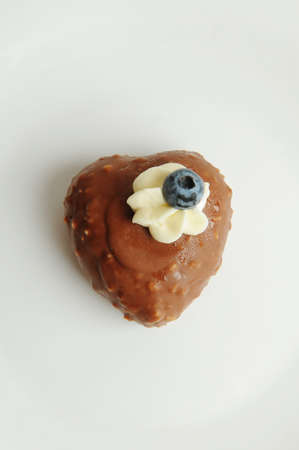 Heart mousse cake in chocolate glaze on a white backgroundの写真素材