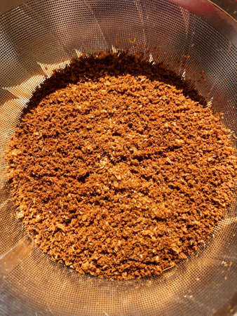 Freshly ground coffee in a metal brewing filter, close-up, pour over methodの写真素材