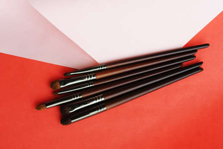 Makeup brushes on pink and red background. beauty conceptの写真素材