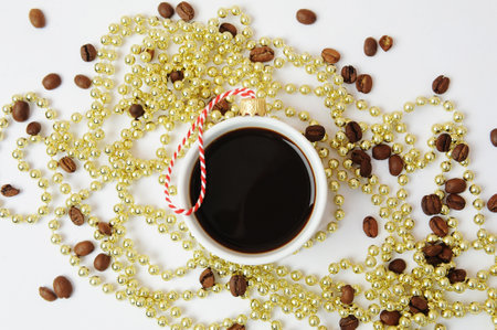 Christmas New Year coffee concept. Cup of black espresso coffee decorated with christmas tree ball. Golden Christmas tree beads. white backgroundの写真素材