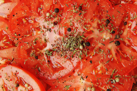 Fresh tomato slices sprinkled with spices and pepper close-up. vegetable food backgroundの写真素材