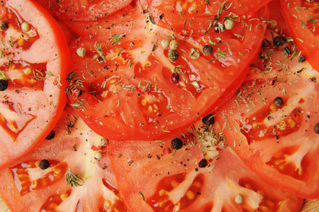 Fresh tomato slices sprinkled with spices and pepper close-up. vegetable food backgroundの写真素材