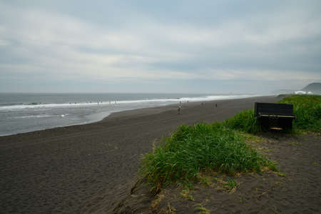 Landscape. Large and beautiful sandy beach of black volcanic sand by the oceanの写真素材