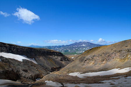 Landscape. a large gorge between the mountains when climbing and an active volcanoの写真素材