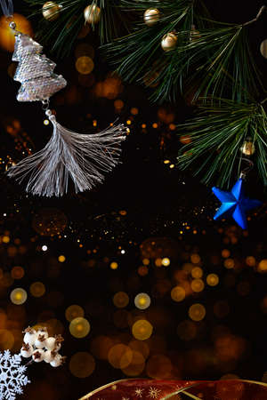 New Year card. Beautiful Christmas tree decorations on a dark background with night lights.の写真素材