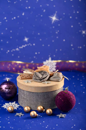 New Year card. beautiful gift box, Christmas tree decorations on a blue background with starsの写真素材