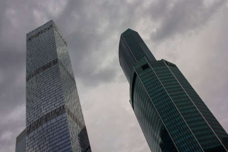 Tall buildings skyscrapers against the clouded sky. Concrete and glassの写真素材