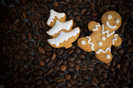 handmade cookies painted glaze lies on roasted coffee beansの写真素材