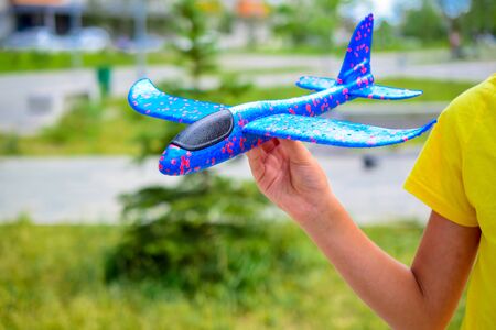 child plays with a model airplaneの写真素材
