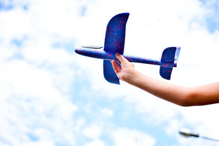 child plays with a model airplane