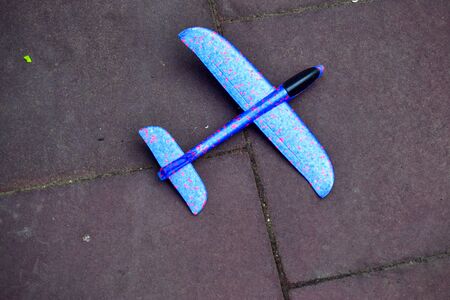 child plays with a model airplaneの写真素材