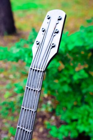 symbolic guitar made of gray metalの写真素材