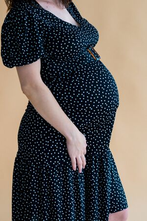 pregnant young woman in dark dressの写真素材