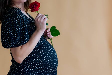 pregnant young woman in dark dressの写真素材