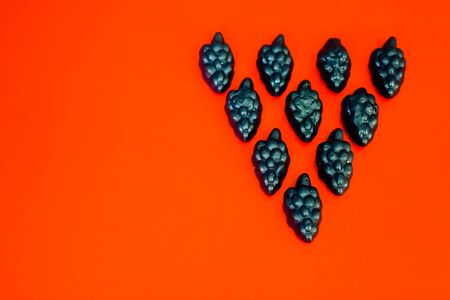 marmalade in the form of grapes on a bright colored backgroundの写真素材