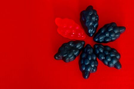 marmalade in the form of grapes on a bright colored backgroundの写真素材