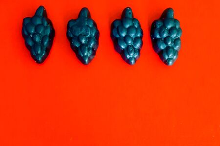 marmalade in the form of grapes on a bright colored backgroundの写真素材