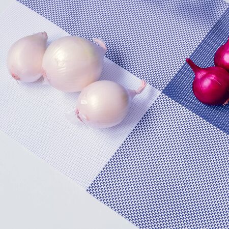 red onion and white onion on a background divided into four partsの写真素材