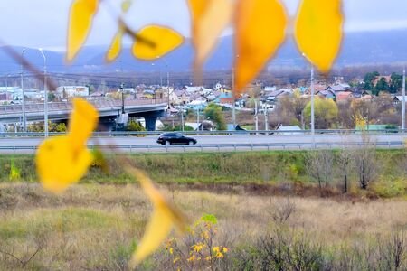 road with fences and signs in autumn dayの写真素材