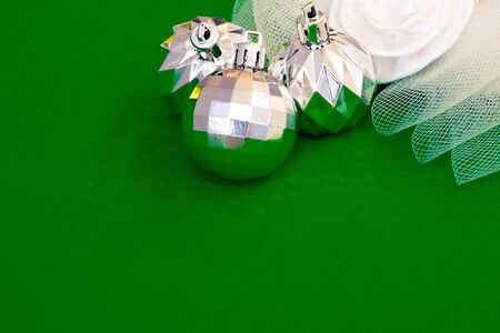 Christmas decoration silver or gold on green tablecloth or clothの写真素材