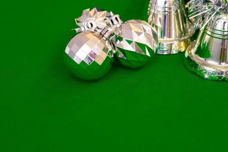 Christmas decoration silver or gold on green tablecloth or clothの写真素材