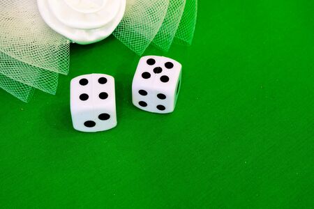 white dice on green cloth or tableclothの写真素材