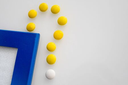 tablets or candies, white and colored on a white table
