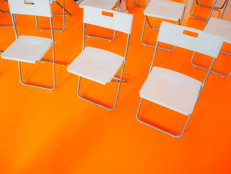 office chairs in white on a background of orange solid floorの写真素材
