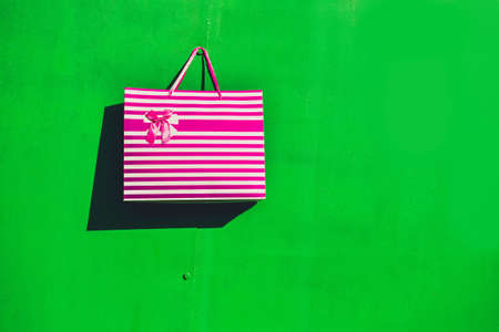 white with red stripes gift bag hanging on the wall
