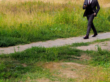 women's or men's feet in summer in the city on a Sunny dayの写真素材