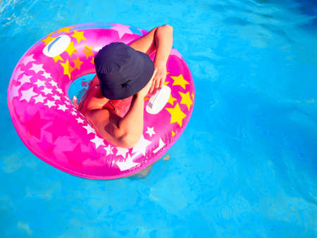 beach with sand and blue water, a girl with a colored circleの写真素材