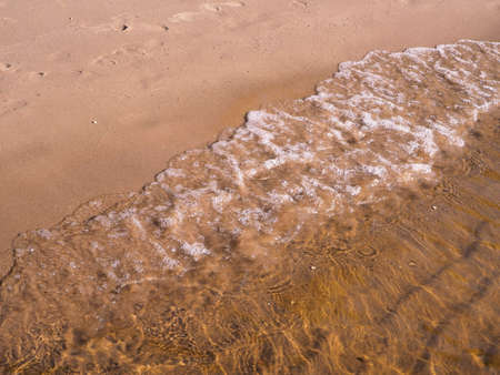 beach with sand and blue water, a girl with a colored circleの写真素材