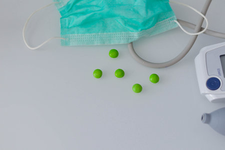 medical mask of bluish-green color next to a medical deviceの写真素材