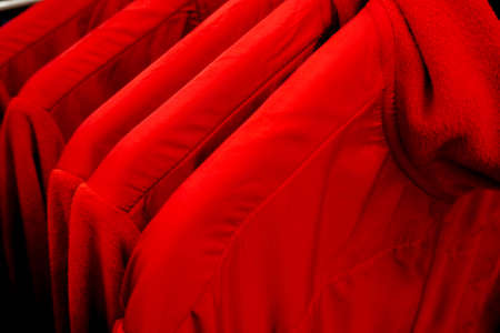 clothes of the same color on a hanger in a storeの写真素材