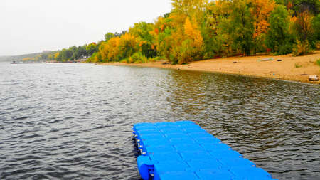 autumn landscape next to a river or lake, cloudy dayの写真素材