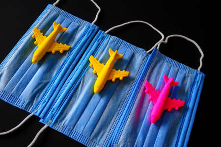 toy planes and medical masks on a colored backgroundの写真素材