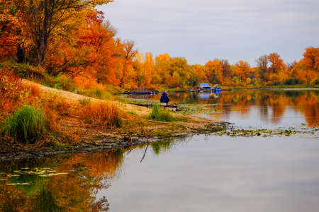 autumn landscape next to a river or lake, cloudy dayの写真素材