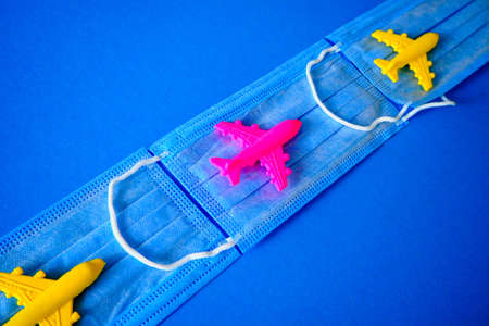 toy planes and medical masks on a colored backgroundの写真素材