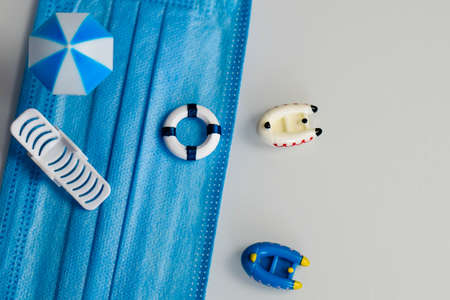 miniatures about relaxing on the beach and protection from viral and bacterial infection on vacation