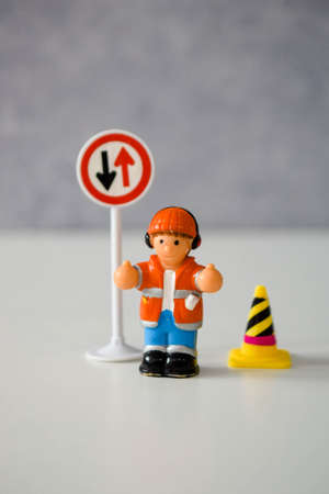 miniature doll - man or woman next to a road signの写真素材