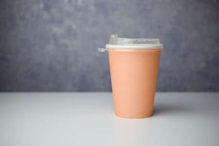 takeaway coffee cup of light brown color in the singularの写真素材