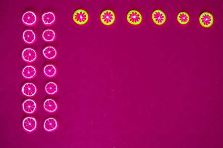 miniature fruits and berries on a red or crimson backgroundの写真素材