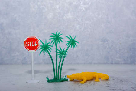 bright yellow toy crocodile in an unusual situationの写真素材