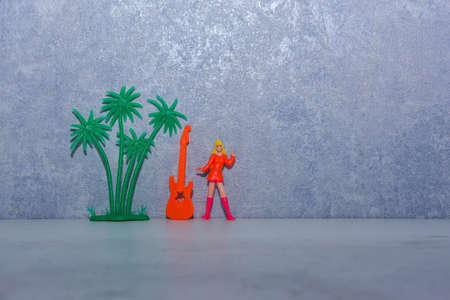 girl in bright clothes with a guitar near the wallの写真素材