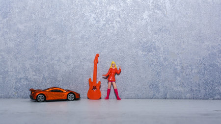 girl in bright clothes with a guitar near the wallの写真素材