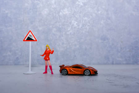 toy girl next to road signs and equipmentの写真素材